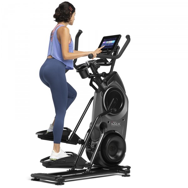 A fitness enthusiast engaging in an intense workout on the BowFlex Max Trainer M9