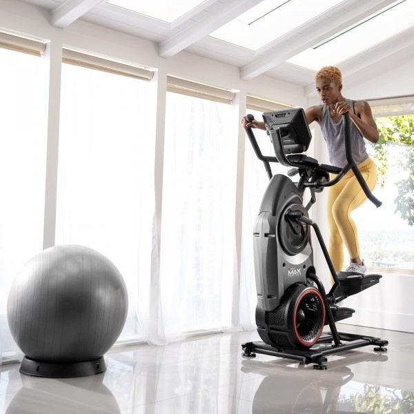 An individual focused during a workout on the BowFlex Max Trainer M9