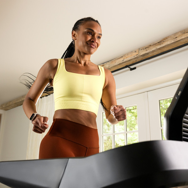 Close-up of a person jogging on the BowFlex T9 treadmill.
