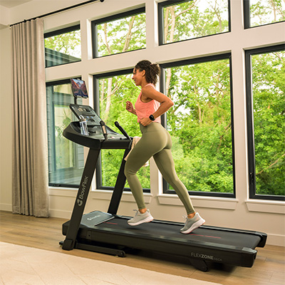 Person running on the BowFlex T6 treadmill at home