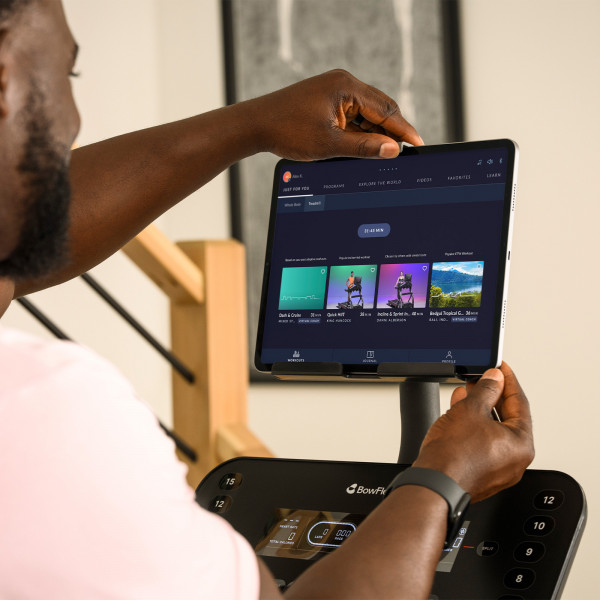 Person adjusting tablet on the BowFlex T6 treadmill
