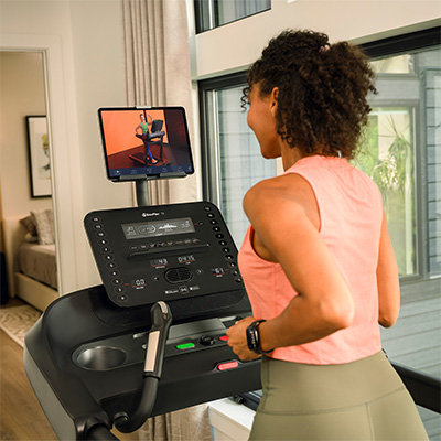 Person following workout video on the BowFlex T6 treadmill