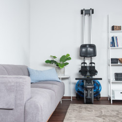 Folded cardiostrong Baltic Pro V2 neatly stored in a corner of the living room.