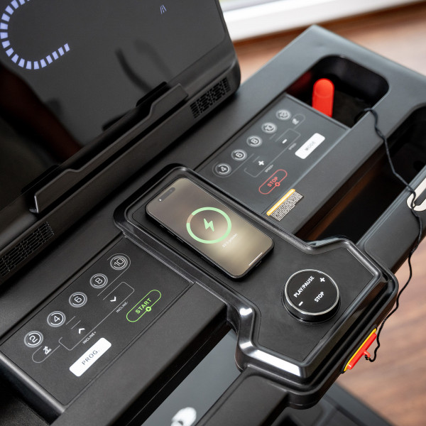 Wireless phone charging pad on the cardiostrong TX30 Treadmill console