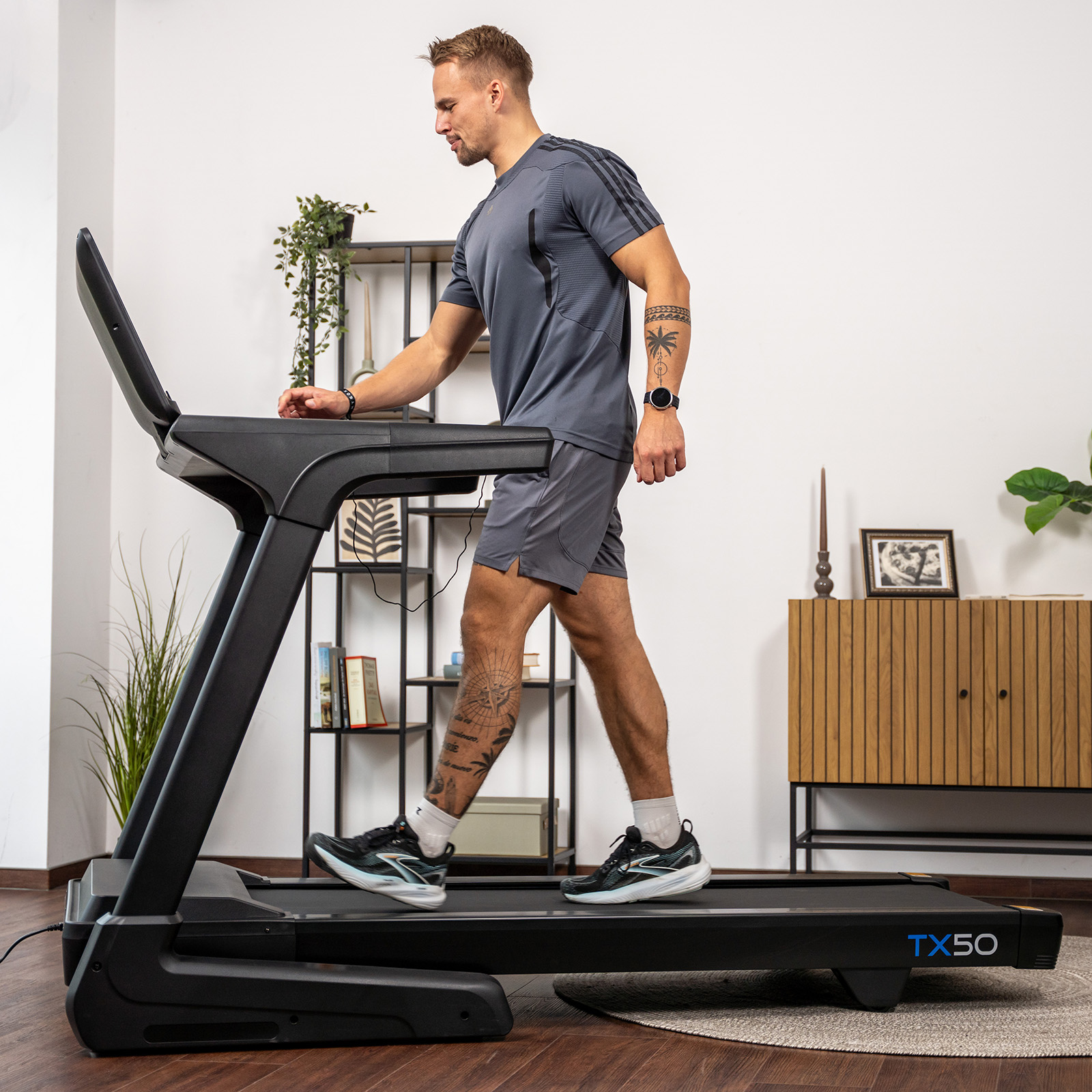User walking on the cardiostrong TX50 Treadmill. 