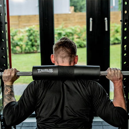 The Taurus Barbell Pad is in use during a person's squat.