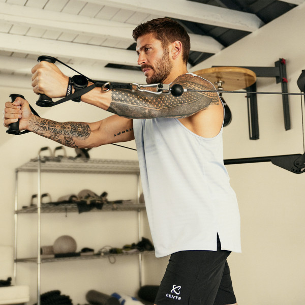 Using the dual pulleys on Centr 1 Home Gym Functional Trainer in a home setting.