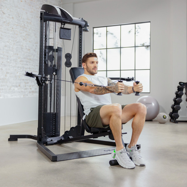 Performing seated chest press on Centr 1 Home Gym Functional Trainer.