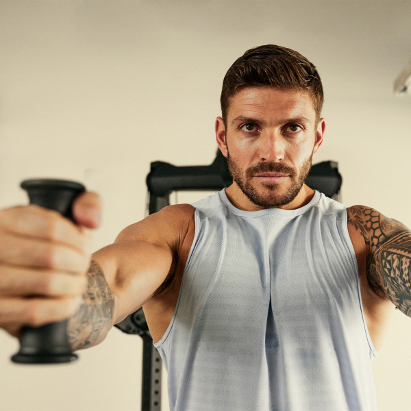 Close-up of a user performing a chest press on Centr 1 Home Gym Functional Trainer.