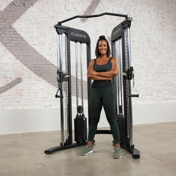 Centr 2 Home Gym Functional Trainer with a person standing confidently beside it.
