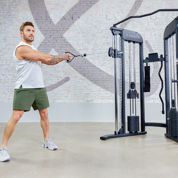 Person demonstrating resistance training with the Centr 2 Home Gym Functional Trainer.
