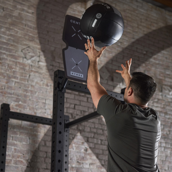 Lifestyle image of the CENTR x HYROX Competition Rig Target, with the model doing a wall ball shot.