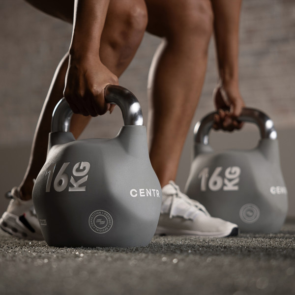 Lifestyle image of a model using a pair of 16kg CENTR x HYROX Competition Octo Kettlebells