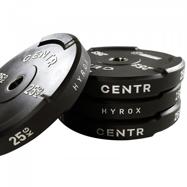 Angled stack of CENTR x HYROX Bumper Plates with branding visible.