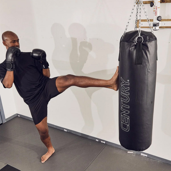 Model performing a front kick on the Century Traditional Hanging Heavy Bag