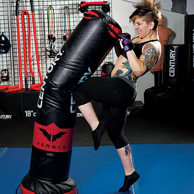 Image of a model kneeing the Century Vs.1 punch bag.
