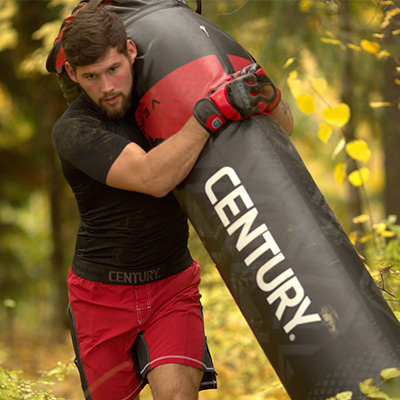 Image of a model running with the Century Vs.1 punch bag over one shoulder.