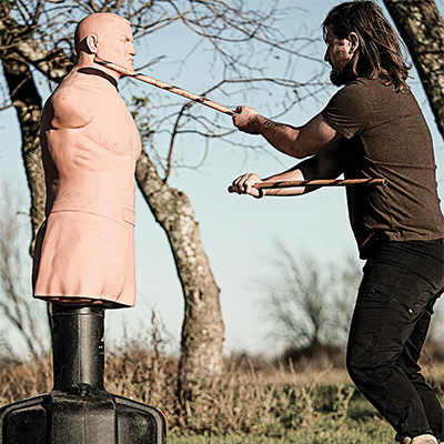 A model using BOB as a weapons training dummy with sticks