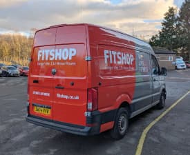 A red and white van seen from the back.