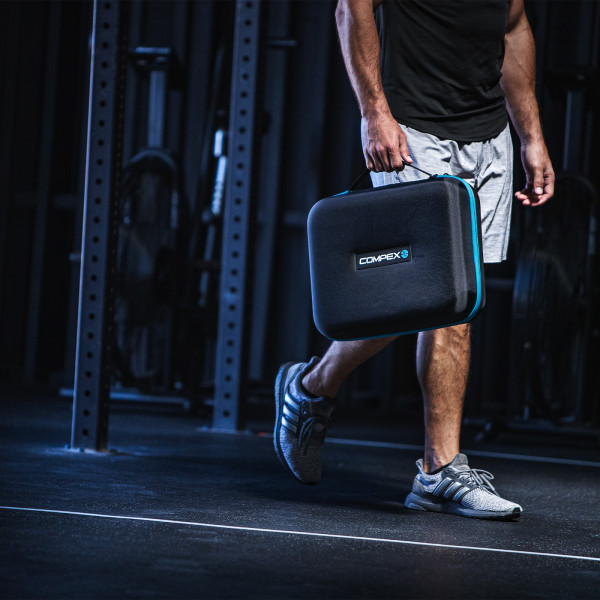 Lifestyle image of the Compex Ayre Compression Boots - Model has the carry case