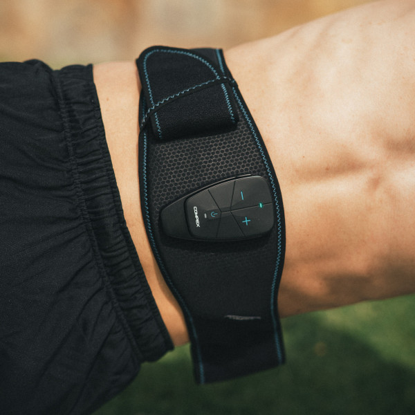 Lifestyle image of the compex core belt 5.0 - image is a close up of a model wearing the belt in a plank exercise.