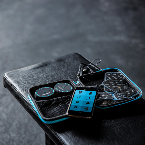 Lifestyle image of the Compex MINI TENS Muscle Stimulator - in a gym environment