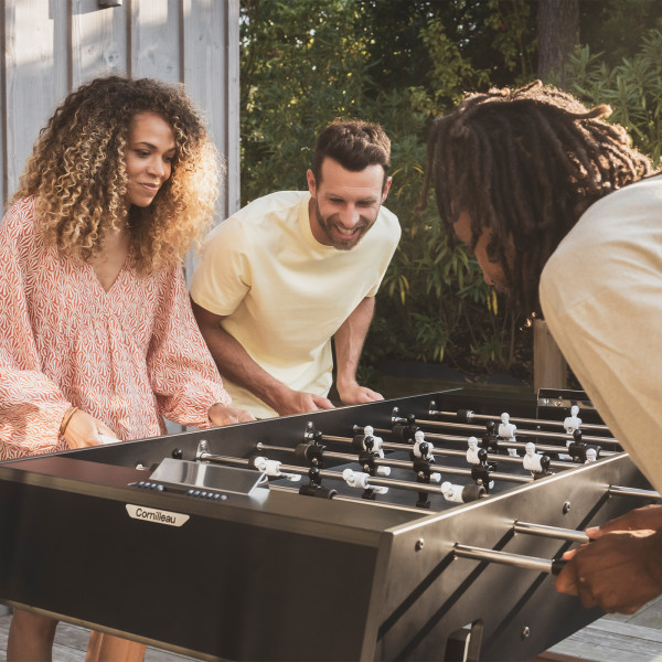 People playing on the Cornilleau Play-Style Origin outdoor football table in black