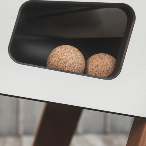 Cork balls in side compartment of the Cornilleau Play-Style Origin outdoor football table in white