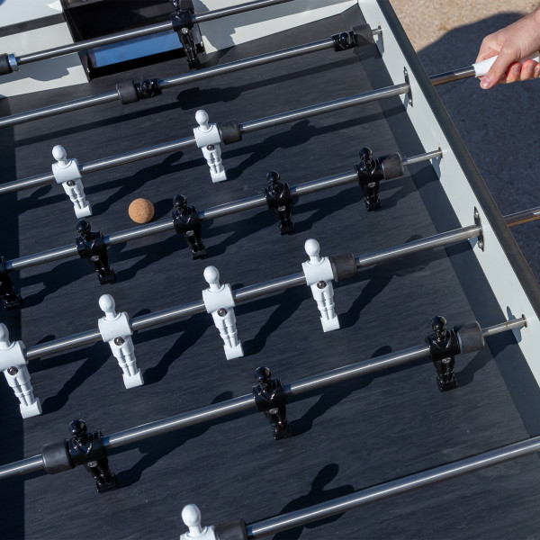 Game in play on the Cornilleau Play-Style Origin outdoor football table in white with cork ball
