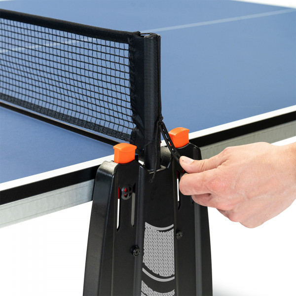 Hand adjusting the net tension on the Cornilleau Challenger Indoor Table Tennis Table