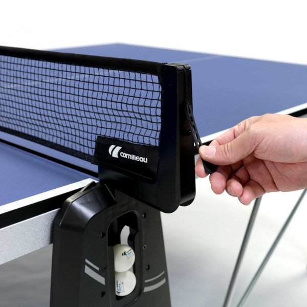 Hand adjusting net tension on the Cornilleau Sport 400 Indoor Table Tennis Table