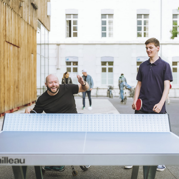 Wheelchair user and standing player having a match on the Cornilleau Urban Outdoor Table Tennis Table