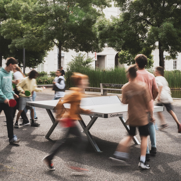 Busy playground scene around the Cornilleau Urban Outdoor Table Tennis Table
