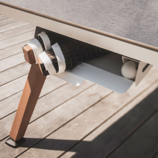Storage drawer with rackets and balls under the white Cornilleau Play-Style Origin table