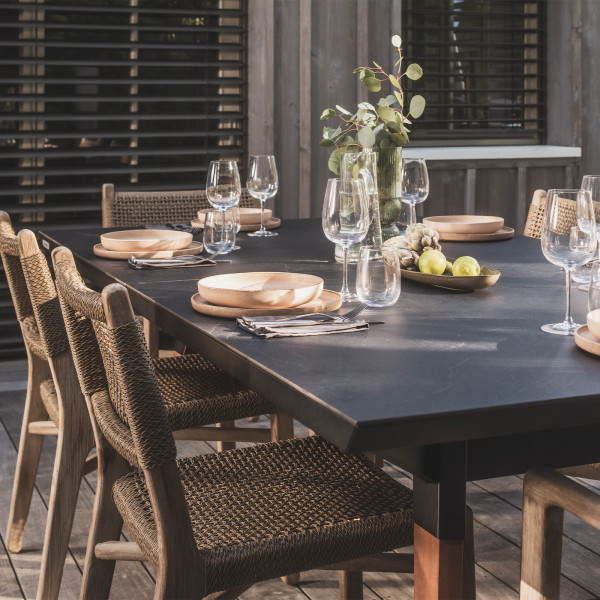 Black Cornilleau Play-Style Origin Medium table set for dining with natural wood chairs
