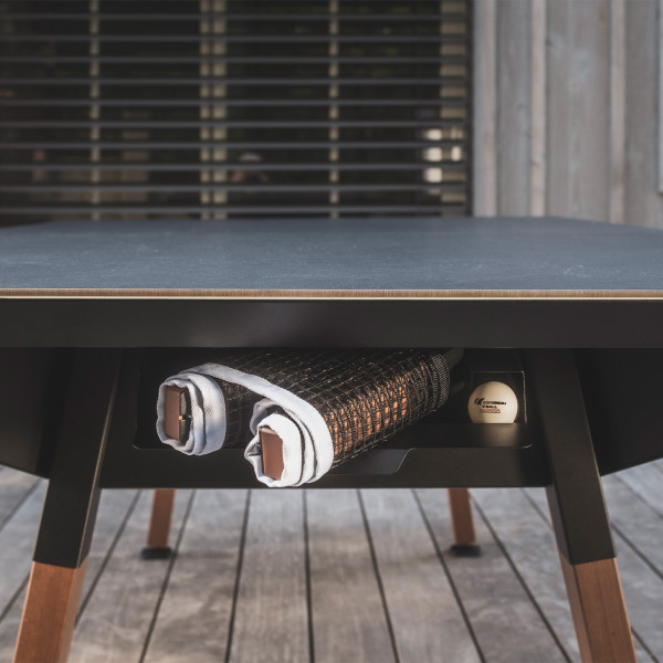 Storage drawer with rackets and balls under the black Cornilleau Play-Style Origin Medium table