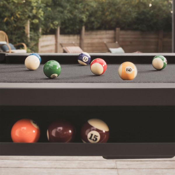 Close-up of pool balls and pockets on the Cornilleau Hyphen with black frame and dark grey cloth