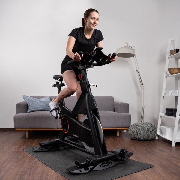 Person on an indoor bike with the curveplate in a home setting.