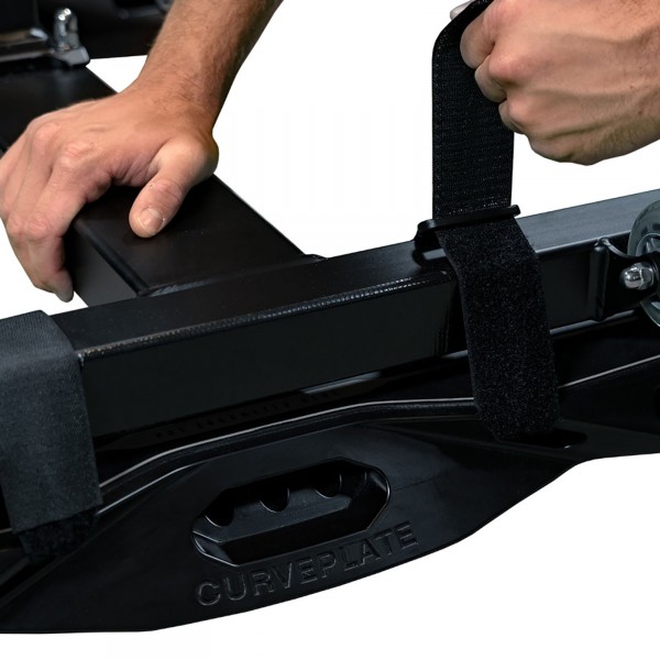 User attaching the curveplate to an indoor bike.