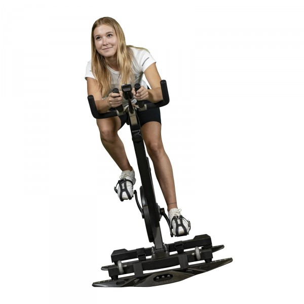 Person working out on an indoor bike with the curveplate attached.
