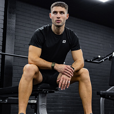 Image of a model sitting on a weight bench