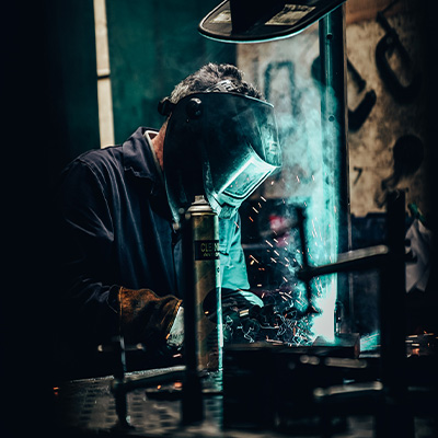 Image of an Exigo engineer welding an Exigo machine