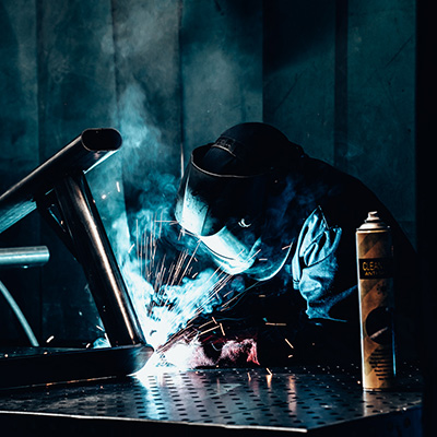 Image of a welder welding a piece of Exigo equipment