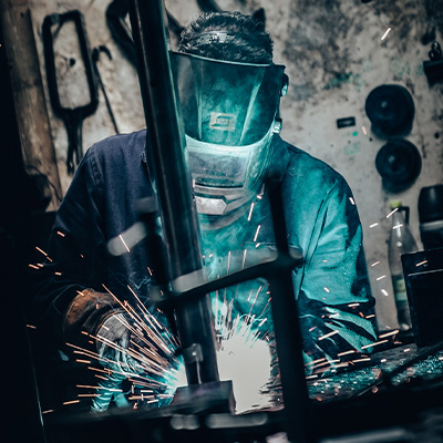 Image of an engineer welding Exigo equipment