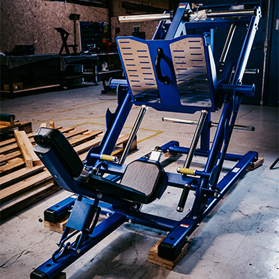 A warehouse image of a custom blue Exigo 45° Leg Press