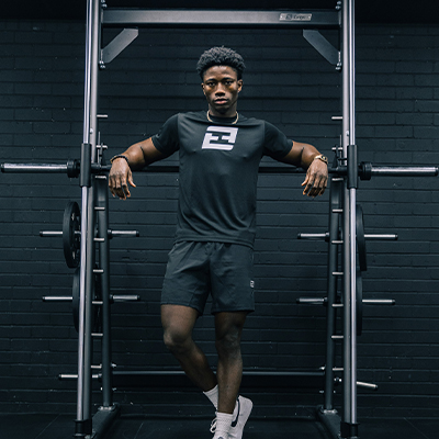 Image of a model posing with the Exigo Smith Machine