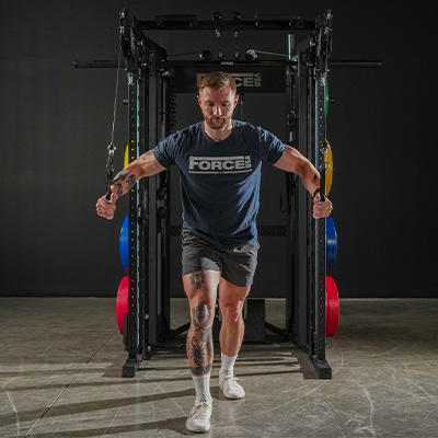 Image of the Force USA V2 with a model performing a cable crossover.