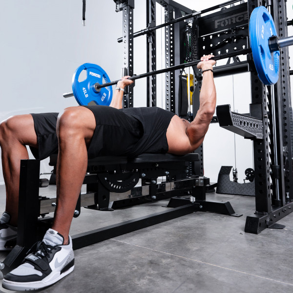 User performing bench press on Force USA C20 Trainer