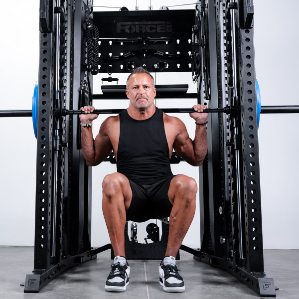 User performing squat on Force USA C20 Trainer