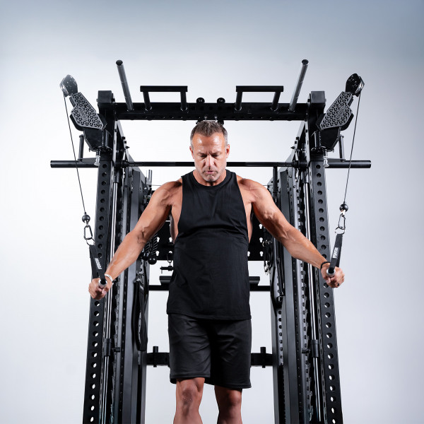 User performing standing cable crossover on Force USA C20 Trainer